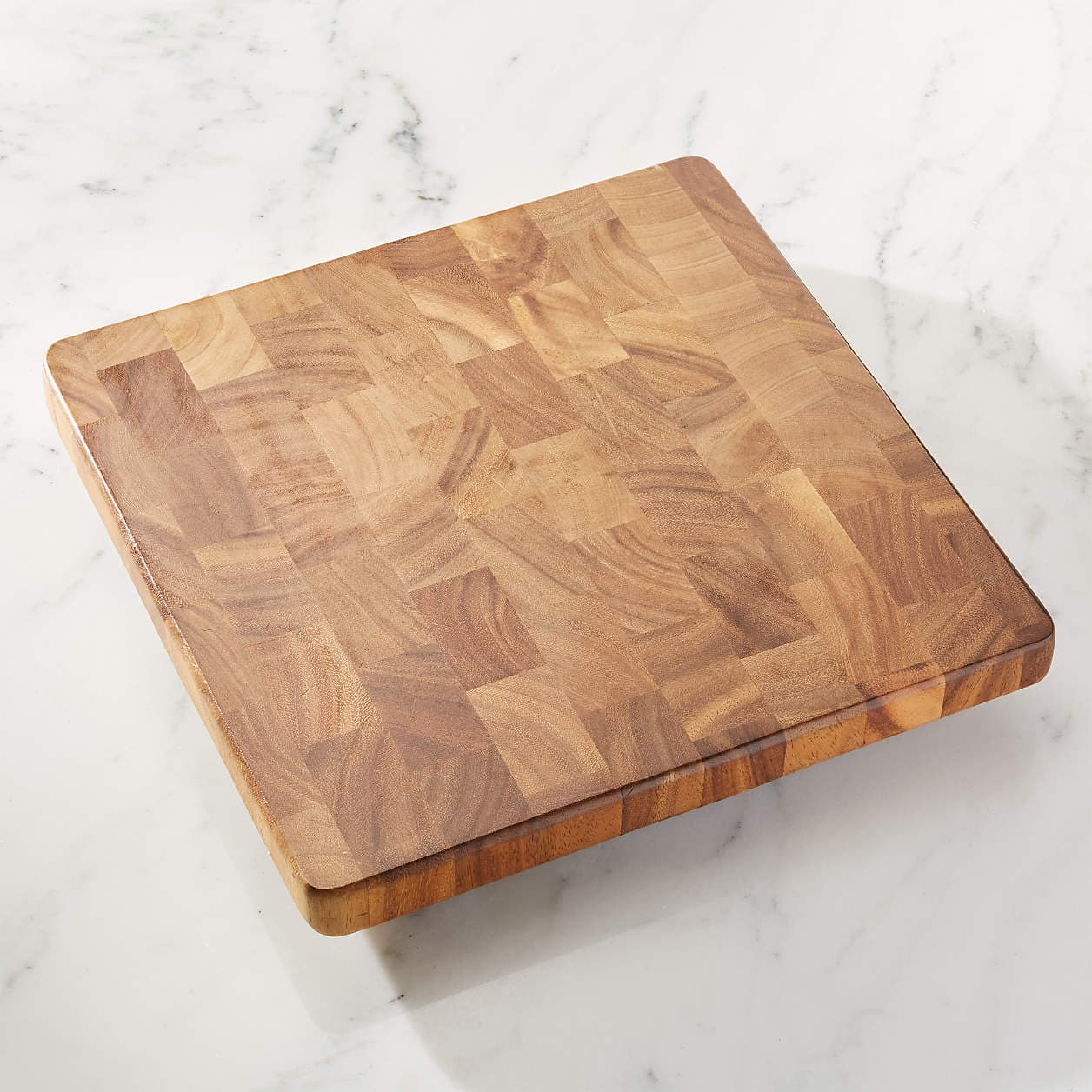 Square acacia end-grain chopping board with a block-patterned surface