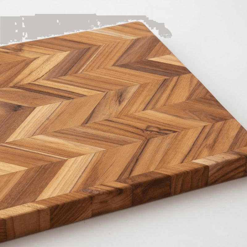 Teak herringbone cutting board with staggered strip pattern